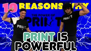 Gal Shweiki and Joey Dominguez flexing in front of The Power of Print banner.