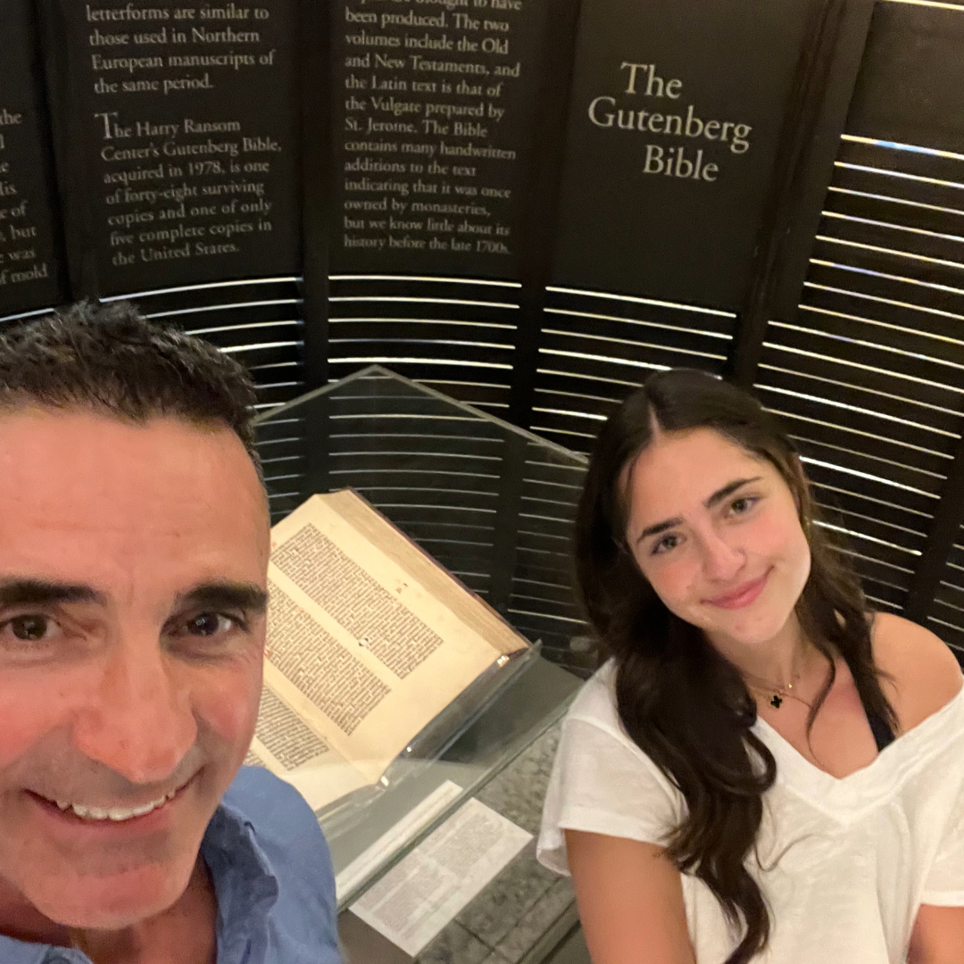 In a story about Gutenberg Bible a photo of man and daughter standing next to the Gutenberg Bible