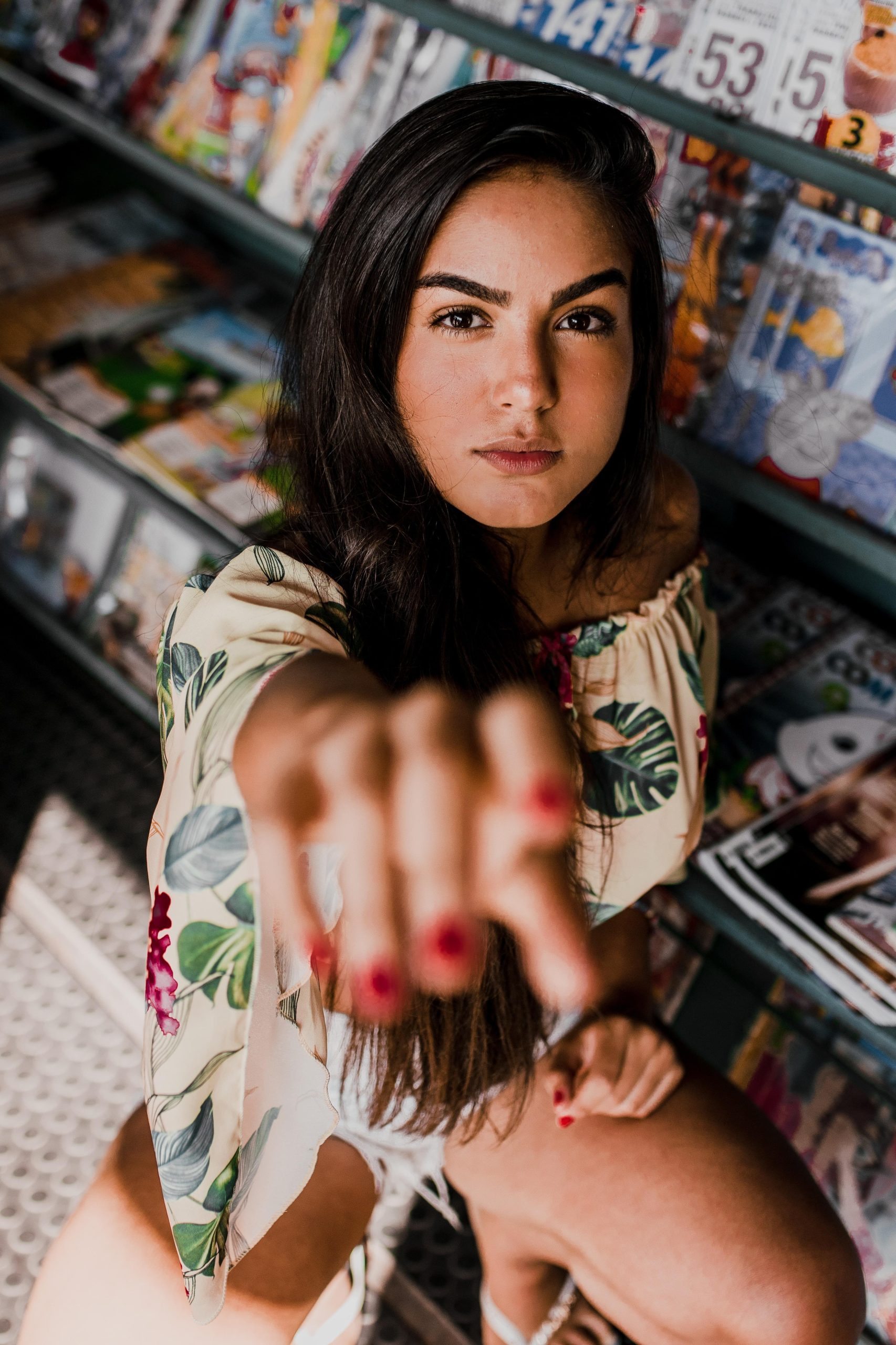 In a story about publishing a magazine a woman reaching out her had in front of a stack of magazines